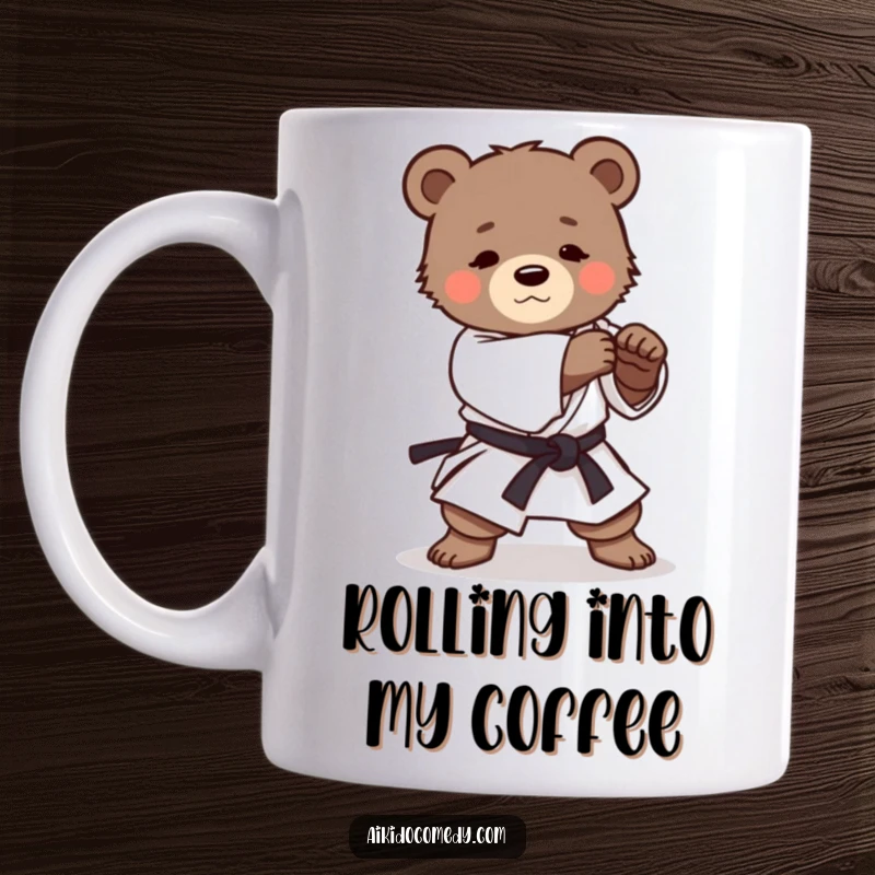 Funny mug featuring a small, determined bear cub in a martial arts uniform practicing a gentle Aikido roll with focused effort.