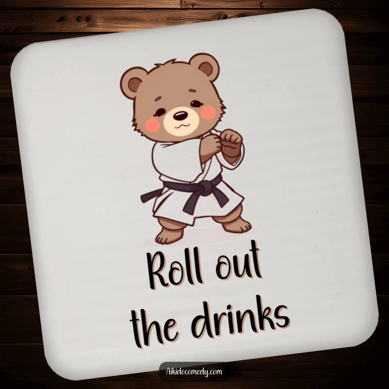 Funny drink coaster featuring a determined bear cub in a martial arts uniform practicing a gentle Aikido roll, protecting surfaces.