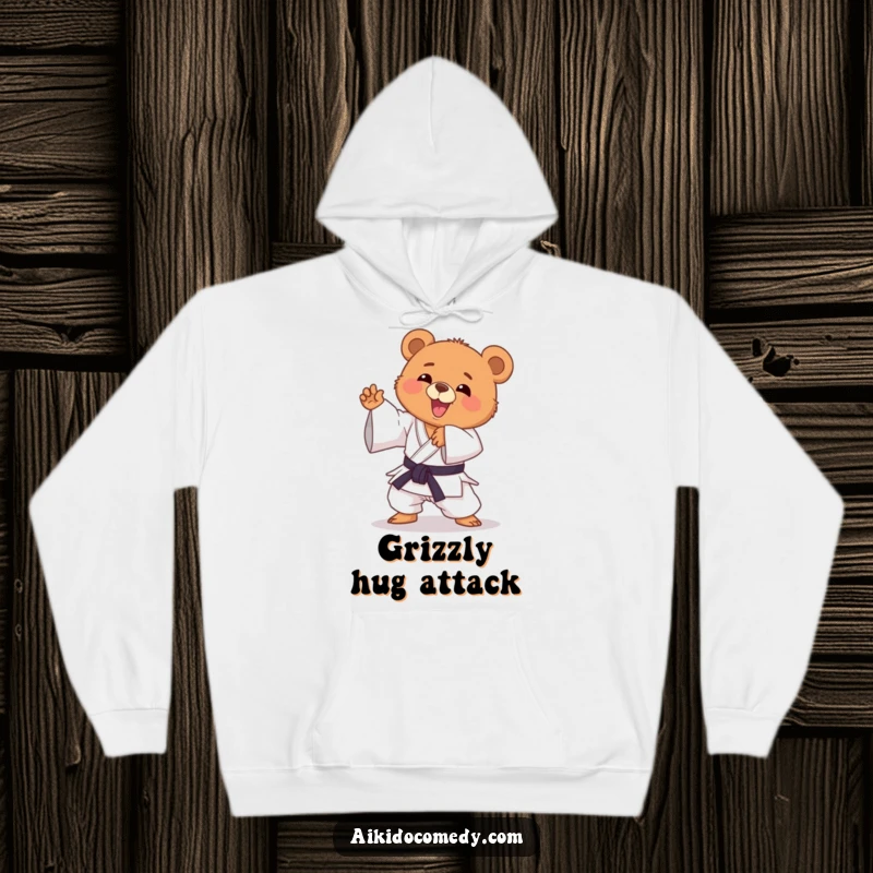 Funny bear cub in gi doing an Aikido move, looking happy on a cozy hoodie. Great funny gift.