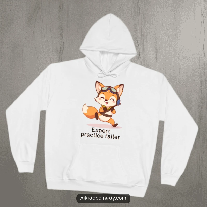 Funny hoodie showing a curious fox in training gear performing a gentle practice fall with a determined look.