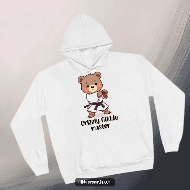 Funny hoodie with a determined bear cub in martial arts attire practicing a smooth Aikido roll, exuding cute concentration.