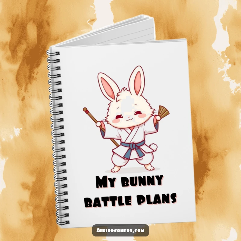 Funny notebook cover with a fluffy bunny in a gi playfully attempting an Aikido sweeping technique, ready for writing.